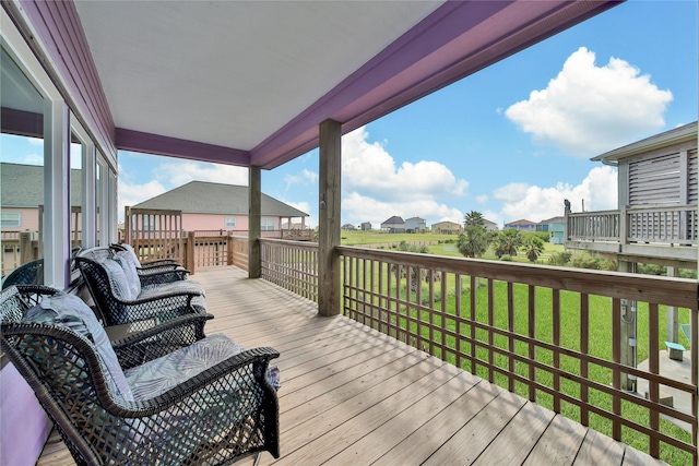 wooden terrace featuring a yard