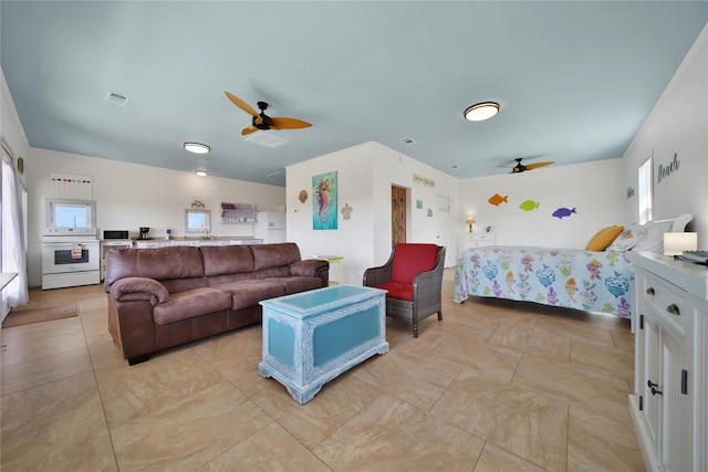 bedroom featuring white refrigerator and ceiling fan