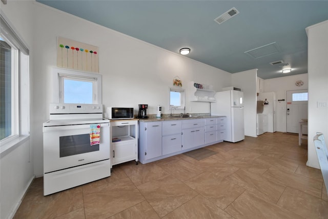 kitchen featuring stone counters, white cabinetry, sink, and white appliances