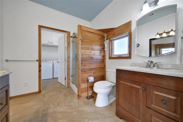 bathroom featuring vanity, toilet, lofted ceiling, and washing machine and clothes dryer