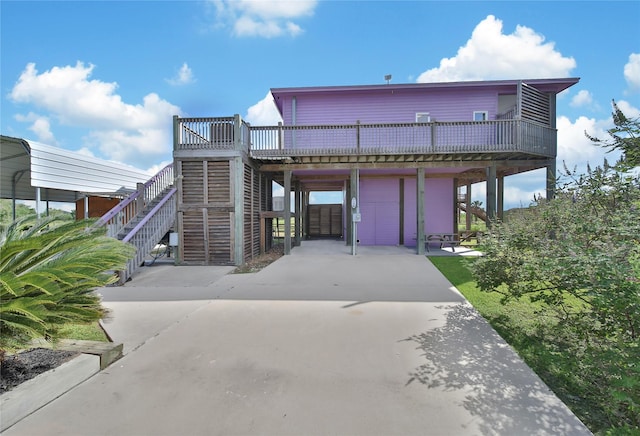 view of front of property with a garage, a carport, and a deck