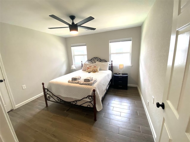 bedroom with ceiling fan and dark hardwood / wood-style floors