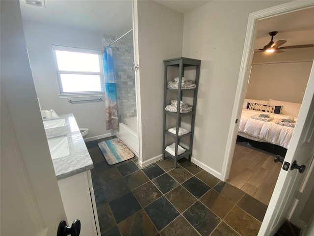 full bathroom featuring ceiling fan, shower / bath combo with shower curtain, vanity, and toilet