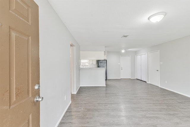 unfurnished living room featuring hardwood / wood-style floors