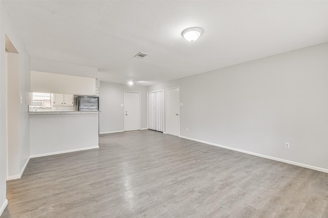 unfurnished living room featuring wood-type flooring