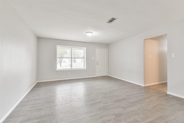 empty room with hardwood / wood-style floors