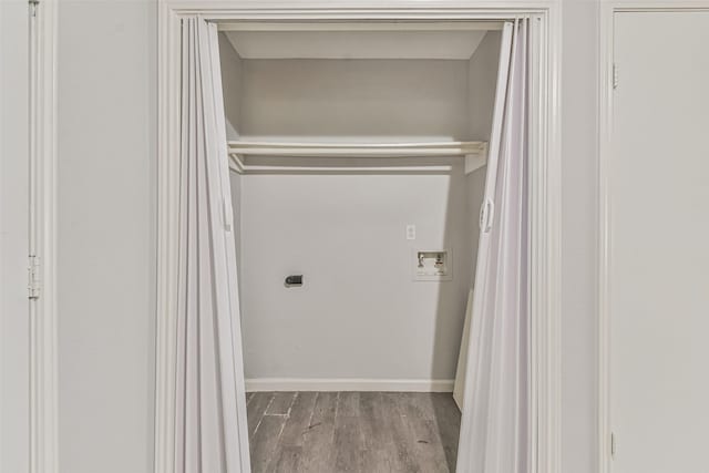 laundry area with hookup for an electric dryer, hookup for a washing machine, and light hardwood / wood-style floors