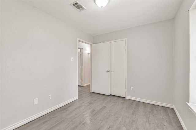 unfurnished bedroom with light wood-type flooring