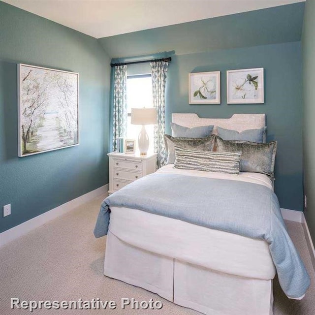 bedroom featuring baseboards, carpet, and lofted ceiling