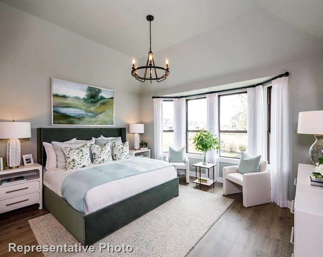 bedroom with lofted ceiling, wood finished floors, baseboards, and a chandelier