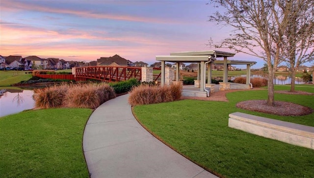 view of home's community featuring a gazebo, a yard, and a water view