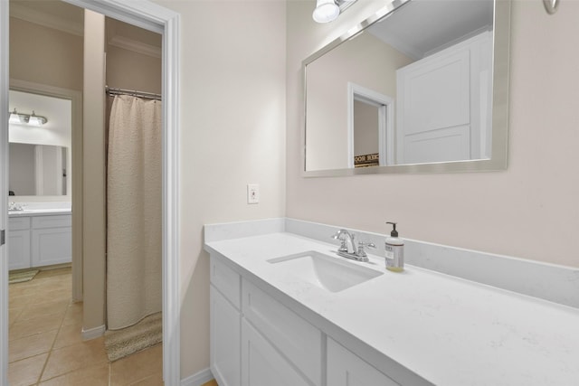 bathroom featuring tile patterned flooring, vanity, and ornamental molding