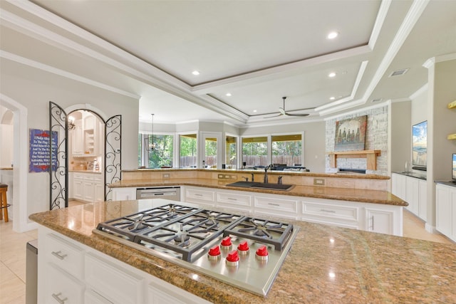 kitchen with white cabinetry, sink, stainless steel appliances, and light stone counters