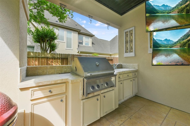 view of patio featuring area for grilling, grilling area, and a water and mountain view