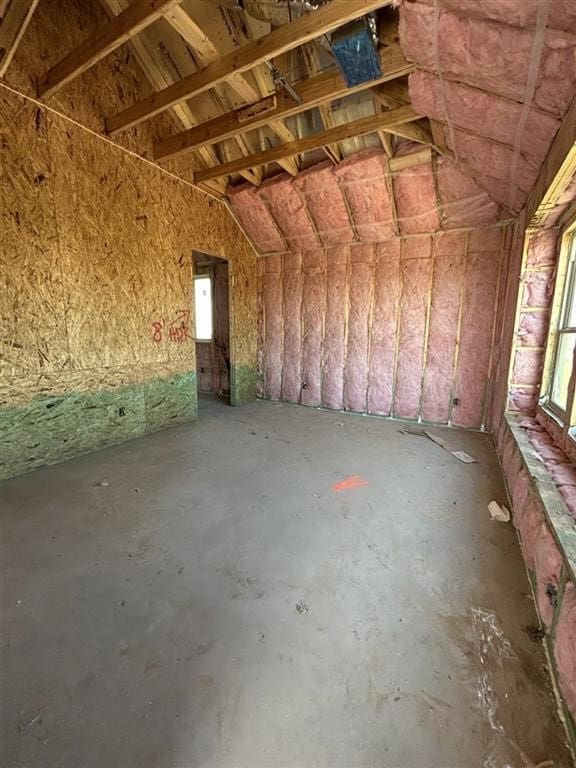 miscellaneous room featuring concrete flooring and vaulted ceiling