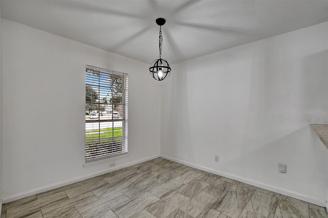 unfurnished room with an inviting chandelier