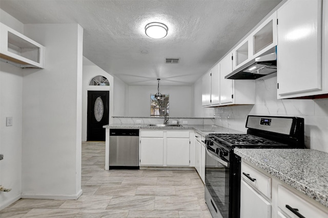 kitchen featuring white cabinetry, extractor fan, hanging light fixtures, and appliances with stainless steel finishes