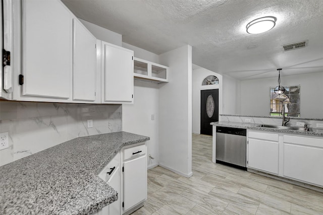 kitchen featuring white cabinets, pendant lighting, stainless steel dishwasher, and sink