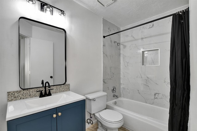 full bathroom featuring vanity, a textured ceiling, shower / tub combo with curtain, and toilet