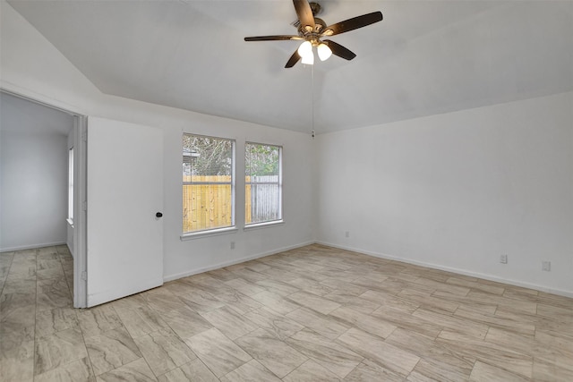 empty room with ceiling fan and lofted ceiling