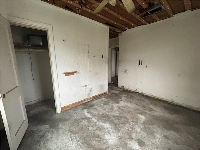 unfurnished bedroom featuring a closet and concrete flooring