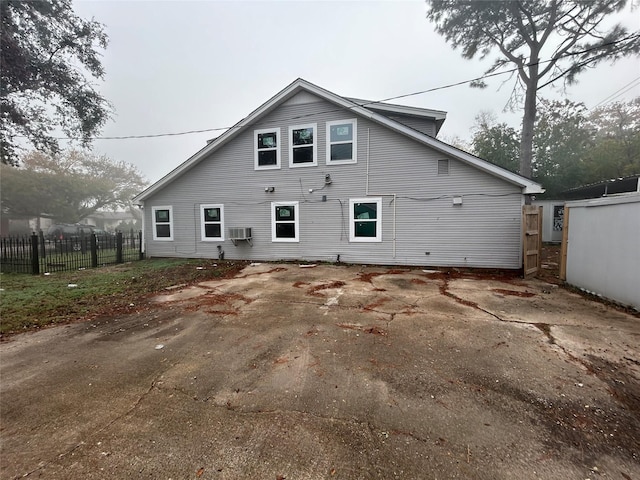 rear view of house with a wall mounted AC