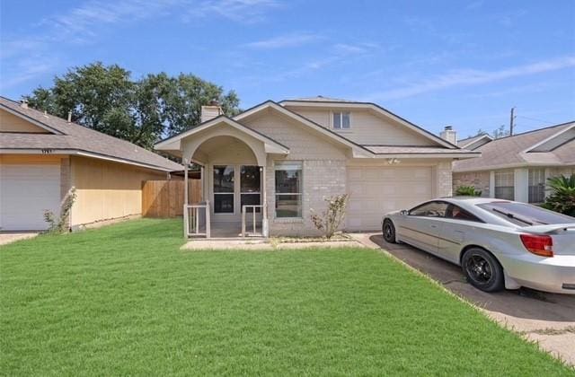 ranch-style home featuring a front lawn and a garage