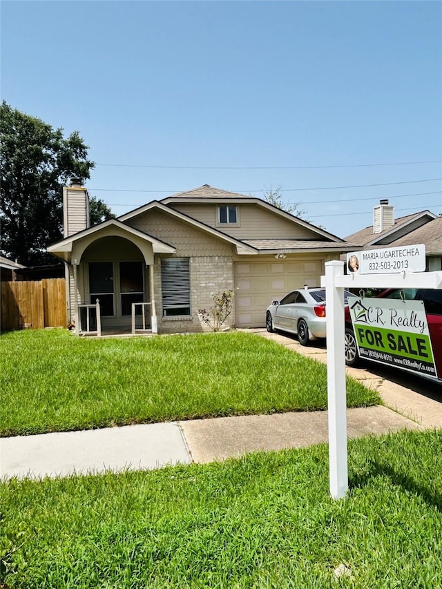 single story home featuring a front yard and a garage