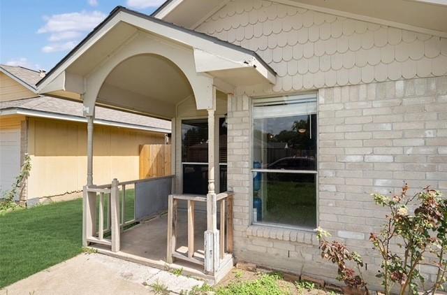 view of exterior entry with a lawn