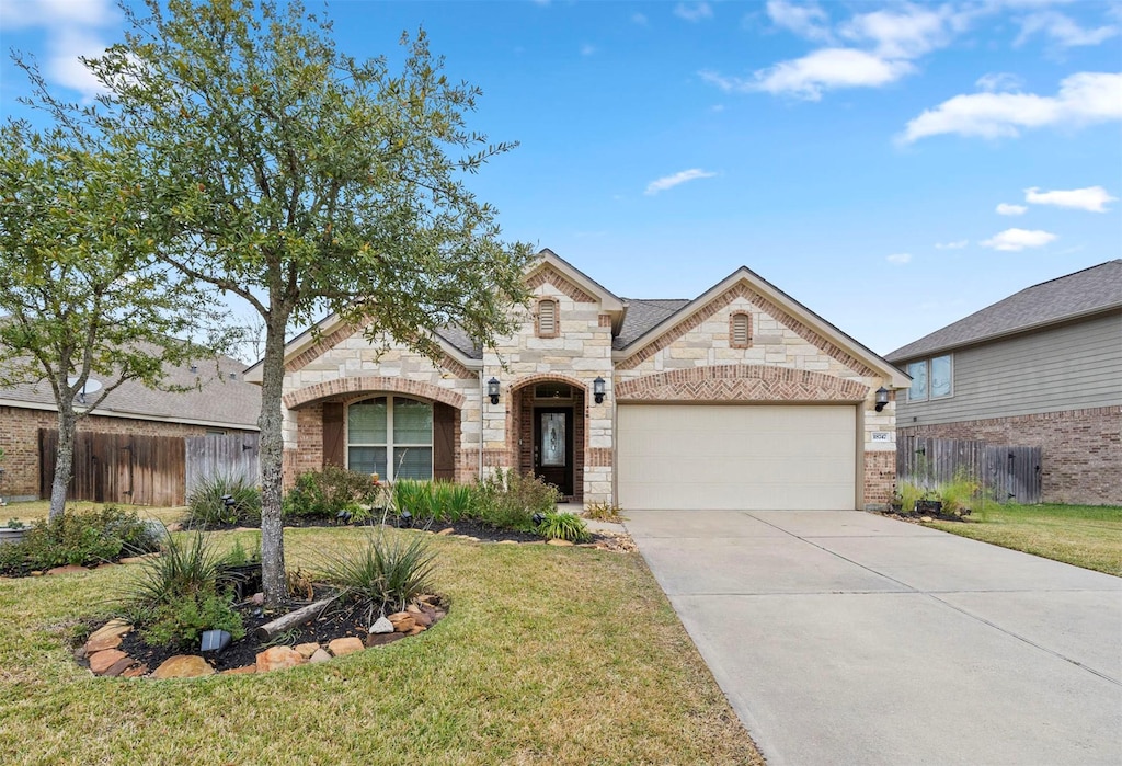 view of front of home with a front yard and a garage