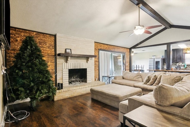 living room featuring ceiling fan, a brick fireplace, vaulted ceiling with beams, dark hardwood / wood-style floors, and plenty of natural light