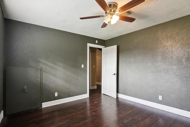 unfurnished bedroom featuring ceiling fan and dark hardwood / wood-style floors