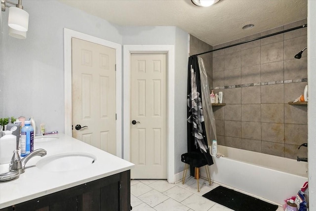 bathroom with a textured ceiling, vanity, and shower / tub combo