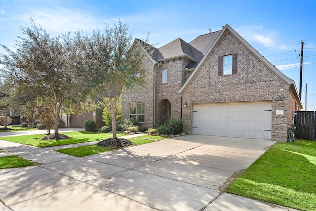 view of front of house with a garage and a front lawn