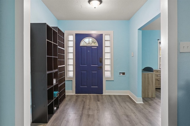 foyer featuring hardwood / wood-style floors and a textured ceiling