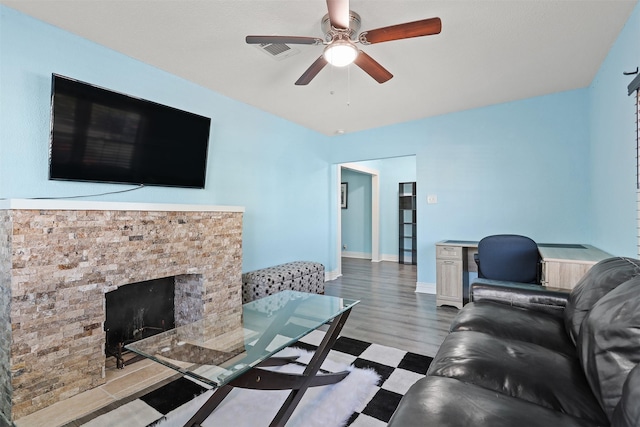 living room with ceiling fan and light hardwood / wood-style floors