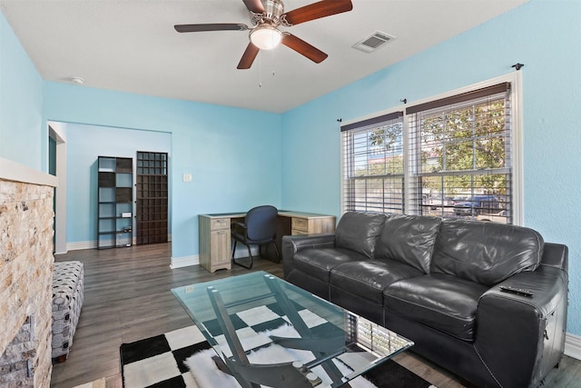 living room featuring ceiling fan and hardwood / wood-style flooring