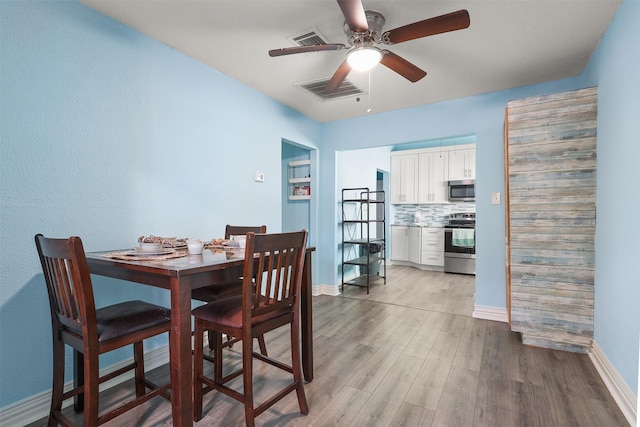 dining area featuring light wood-type flooring and ceiling fan