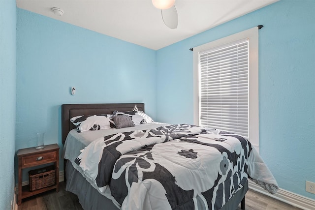 bedroom featuring wood-type flooring and ceiling fan