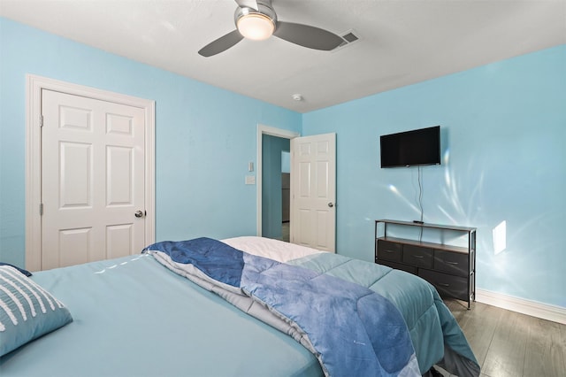 bedroom with ceiling fan and hardwood / wood-style flooring