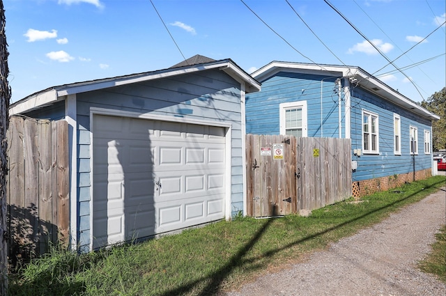 view of property exterior with a garage and an outbuilding