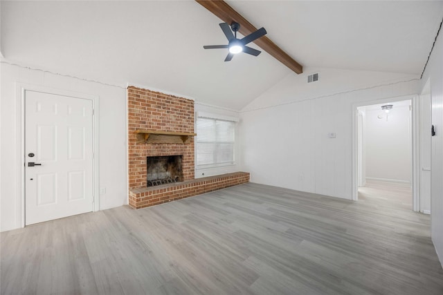 unfurnished living room featuring vaulted ceiling with beams, ceiling fan, light hardwood / wood-style floors, and a fireplace