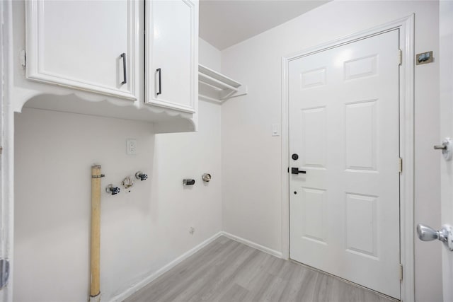 washroom featuring cabinets and light wood-type flooring