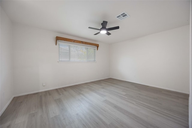 empty room with light hardwood / wood-style floors and ceiling fan