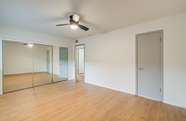 unfurnished bedroom with ceiling fan and light hardwood / wood-style floors