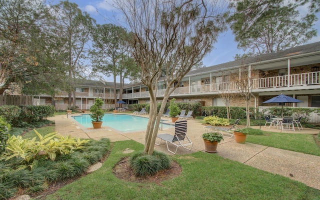 view of swimming pool with a yard and a patio