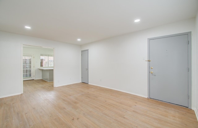 empty room with light hardwood / wood-style floors