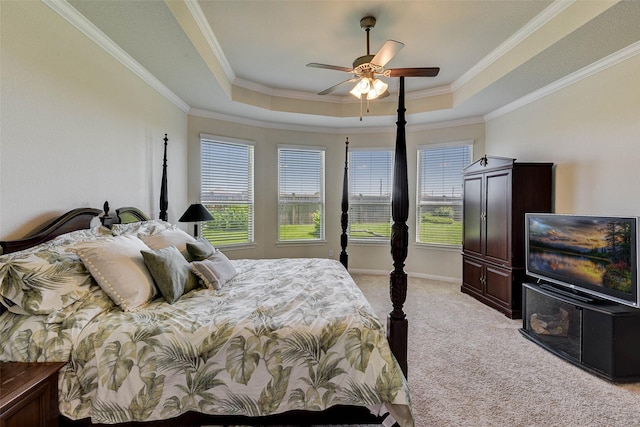 carpeted bedroom featuring a raised ceiling, ceiling fan, and ornamental molding