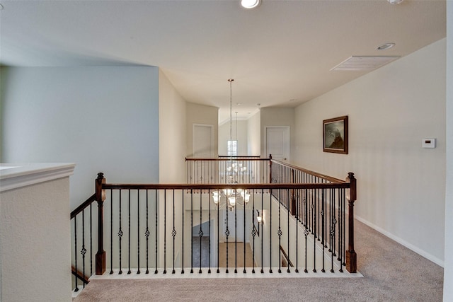 stairway with carpet and a chandelier