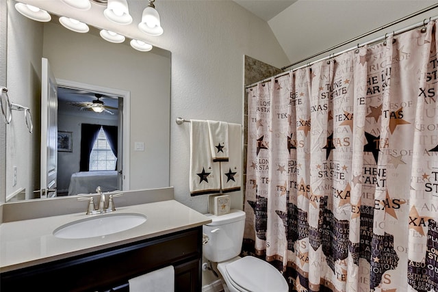 bathroom with vanity, vaulted ceiling, ceiling fan, toilet, and curtained shower